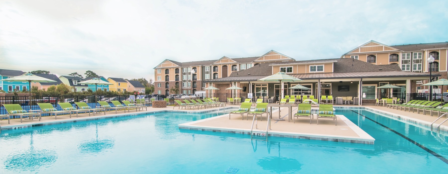 a swimming pool with lounge chairs and umbrellas