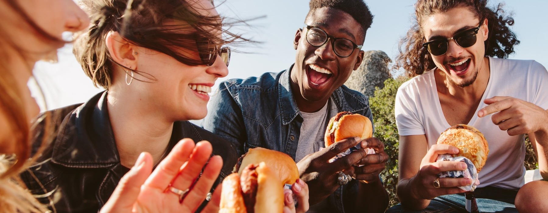 a group of people eating burgers
