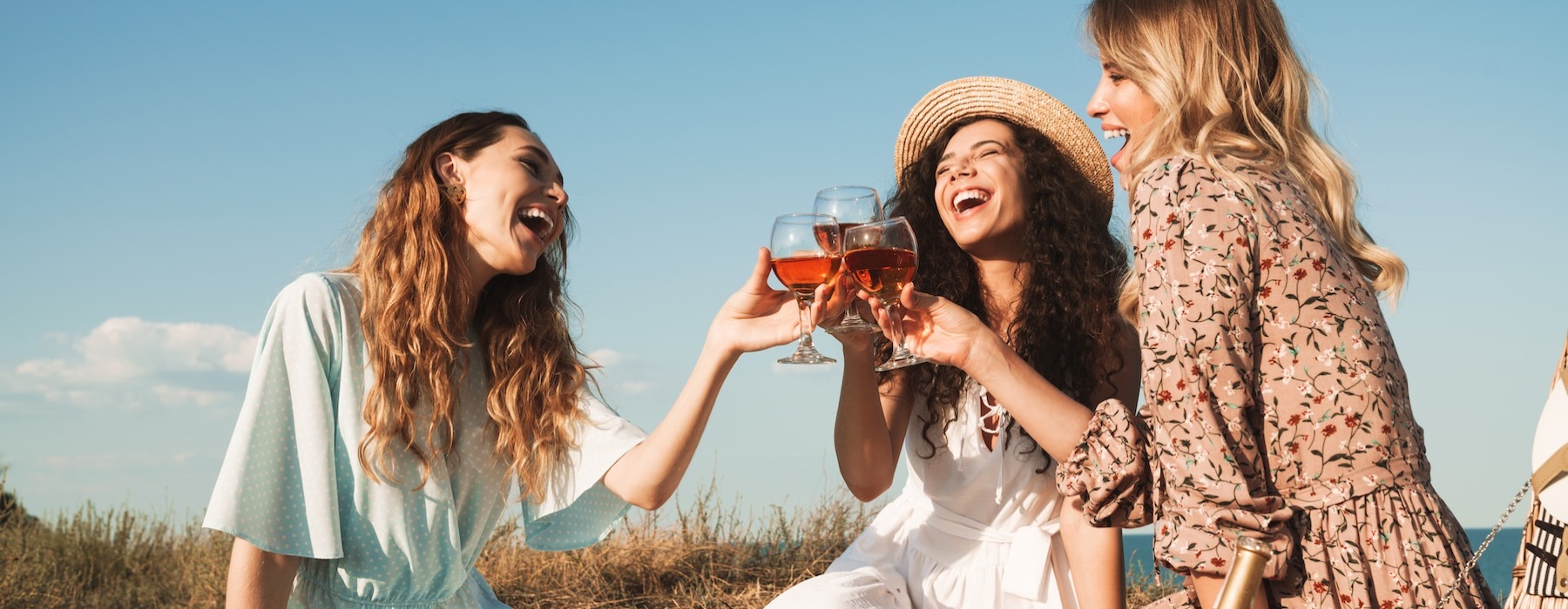 a group of women having table with a basket of food