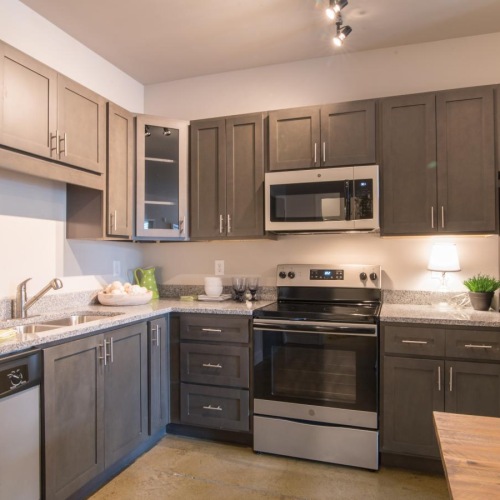 a kitchen with grey cabinets