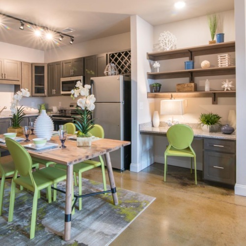 a kitchen with a dining table and chairs