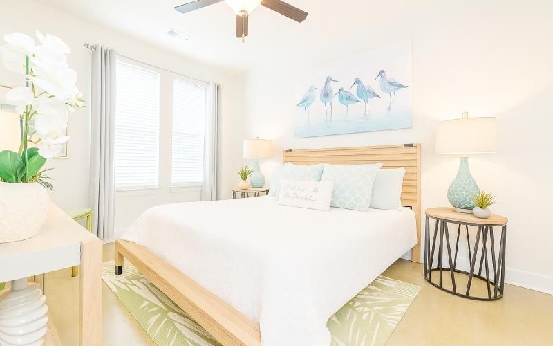 a bedroom with a bed and lamps
