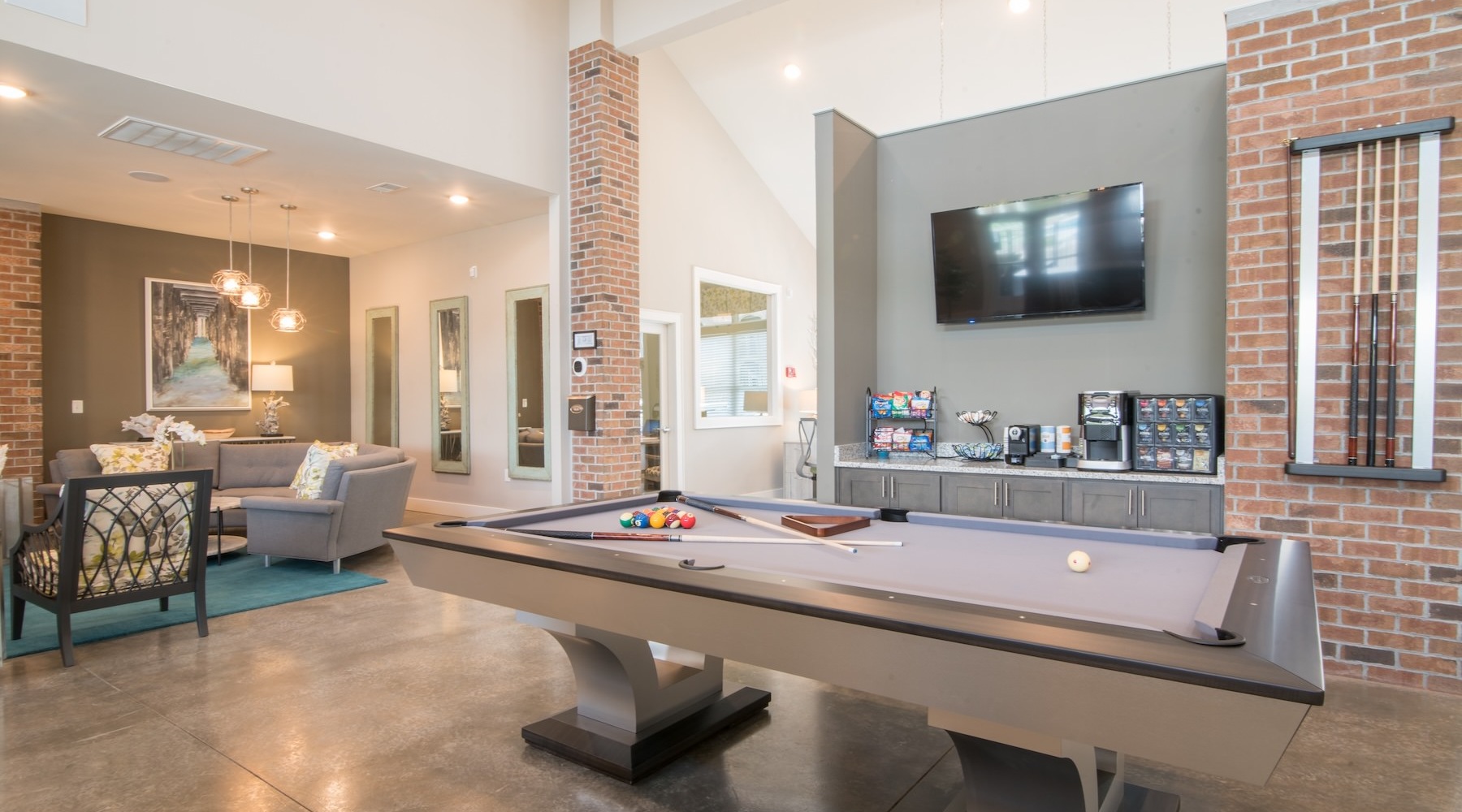a clubroom with a pool table and a tv