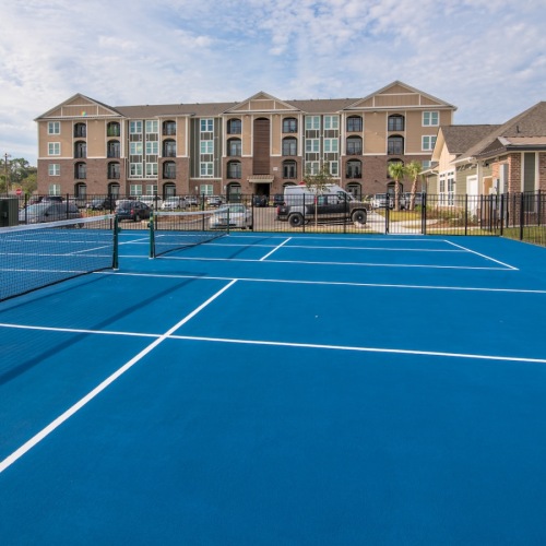 a tennis court in front of a building